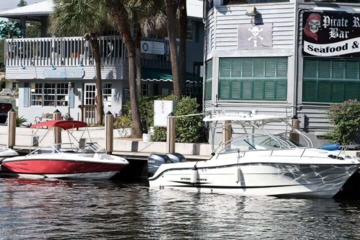 Boats docked at waterfront restaurants on the New River, Fort Lauderdale
