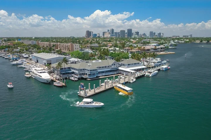 Aerial drone view of Riverfront Marina on the New River with downtown Fort Lauderdale behind