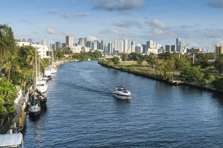 Aerial view of a South Florida canal leading toward the Miami skyline